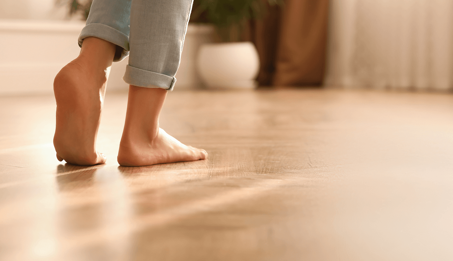 Photo d'une personne marchant pied nue dans sa maison grâce à un chauffage au sol relié à une pompe à chaleur Air-Eau